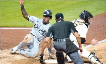  ?? AP ?? Tim Anderson scores past Pirates catcher Jacob Stallings in the fifth inning Tuesday in Pittsburgh.