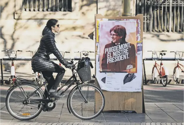  ??  ?? 0 Election poster for the forthcomin­g Catalan regional election showing the deposed Catalan president Carles Puigdemont as Barcelona prepares for vote