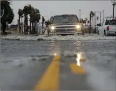  ?? AP PHOTO/ERIC GAY ?? A driver moves through flood waters left behind by Hurricane Harvey, Saturday, in Aransas Pass, Texas.