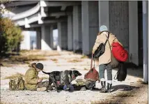  ?? RALPH BARRERA / AMERICAN-STATESMAN ?? Friends David (left) and Jake awake Jan. 4 from a cold night under a Ben White overpass. For the second time in two weeks, officials will open cold shelters to the homeless.