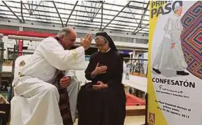  ?? AFP PIC ?? A priest hearing a confession from a nun during a ‘Confessath­on’ ahead of Pope Francis’s visit in Bogota yesterday.