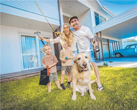  ?? Picture: Nigel Hallett ?? Kimberley and Kyle Bate, with sons Lennox, 5, and Spencer, 2, and dog Winston, are looking to sell their renovated Mermaid Waters home. The family is aiming is to live mortgage-free.