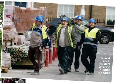  ??  ?? Men at work: Builders on a site in Dublin this week