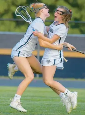  ?? DOUG KAPUSTIN/FOR BALTIMORE SUN MEDIA ?? Manchester Valley’s Erin Herrold, left, and Addison Meyer celebrate after Herrold’s gamewinnin­g goal in overtime of Monday’s Class 2A West Region I final against Glenelg.