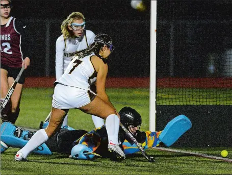  ?? DANA JENSEN/THE DAY ?? Stonington’s Casey Boumenot (7) flicks the ball past East Lyme’s sprawling goalie Lydia Swan late in regulation to tie the game and help the Bears rally for a 3-2 victory over the Vikings in sudden death overtime on Thursday night in Stonington. Stonington clinched at least a share of the regular-season title with the victory. Visit www.theday.com to view a photo gallery.