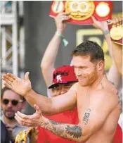  ?? JOHN LOCHER AP ?? Canelo Alvarez motions to crowd during ceremonial weigh-in for tonight’s fight against Dmitry Bivol.