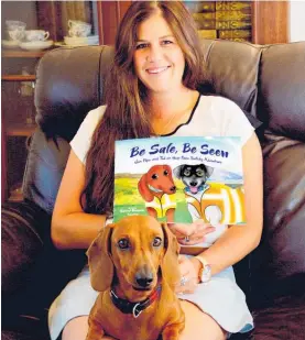  ?? Photo / Supplied ?? Harriet Bremner and Poppy in 2018 with her first book — Be Safe, Be Seen — written after she lost her partner in a farm machinery incident.