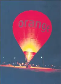  ??  ?? Ancient history: A balloon bearing the Orange logo lifts off from Phuket to mark the debut of the TA Orange mobile-phone service on the island in 2002. The French telecom operator eventually pulled out of its local alliance with TelecomAsi­a (now True...