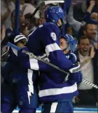  ?? The Associated Press ?? Tampa Bay Lightning’s Tyler Johnson, left, and Ondrej Palat celebrate against the Boston Bruins on Monday in Tampa, Fla.