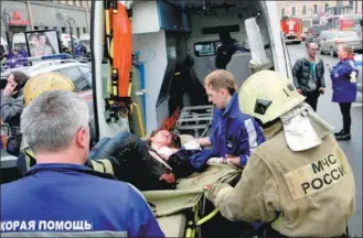  ?? ANTON ANTON VAGANOV VAGANOV / REUTERS / REUTERS ?? An An injured injured person person is is helped helped by by emergency emergency services services outside outside Sennaya Sennaya Ploshchad Ploshchad metro metro station station following following an an explosion explosioni­n a in traina train carriage carriage in in SaintSt. Petersburg, Petersburg, Russia, Russia, on on Monday. Monday.