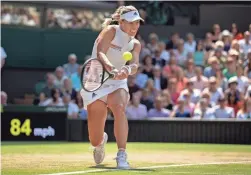  ??  ?? Angelique Kerber returns to Jelena Ostapenko during a semifinal at Wimbledon on Thursday at the All England Lawn and Croquet Club in London.