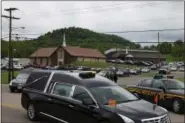  ?? ASSOCIATED PRESS FILE ?? Hearses for six of the eight members of the Rhoden family found shot at four properties near Piketon, Ohio, depart during funeral services from Dry Run Church of Christ in West Portsmouth, Ohio.