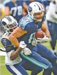  ?? THE ASSOCIATED PRESS ?? Tennessee Titans wide receiver Eric Decker is brought down by Los Angeles Rams cornerback Nickell Robey-Coleman during the second half Sunday.