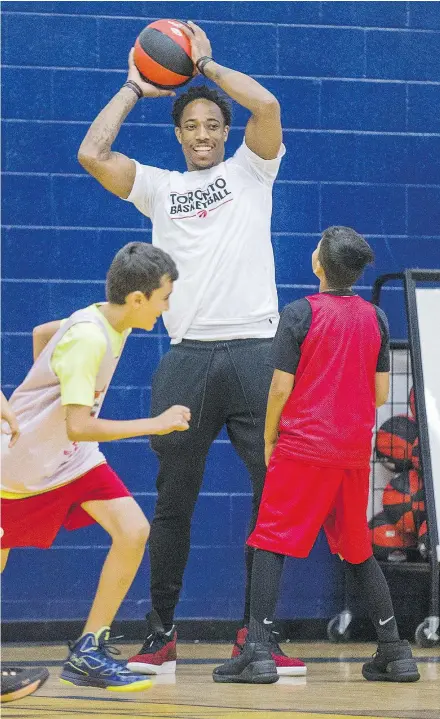  ?? ERNEST DOROSZUK/POSTMEDIA ?? DeMar DeRozan hit the floor with young players at the Raptors Basketball Academy on Tuesday at Humber College in Toronto.