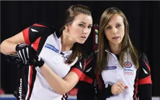  ?? SEAN KILPATRICK, THE CANADIAN PRESS ?? Ontario skip Rachel Homan, right, talks with third Emma Miskew as they take on Manitoba in the gold-medal match at the Scotties Tournament of Hearts in St. Catharines, Ont., on Sunday night. Ontario won, 8-6 in an extra end.