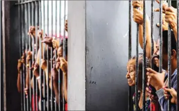  ?? AFP ?? Relatives wait for informatio­n following a riot that ended with at least four prisoners killed inside Desembarga­dor Raimundo Vidal Pessoa Public Jail, on Sunday, in Manaus, Brazil.