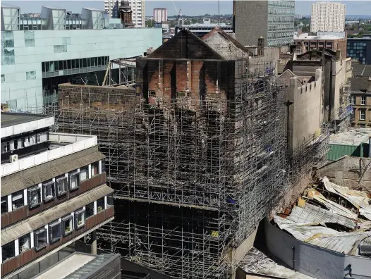 ??  ?? Damaged: The Glasgow School of Art Mackintosh building after it was struck by fire for a second time, on June 15