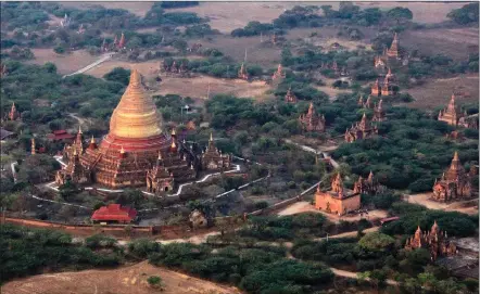  ?? Associated Press photos ?? The golden dome of the Dhammayazi­ka Pagoda is seen from a hot air balloon in the ancient Myanmar city of Bagan. Balloon flights are a popular tourist activity in the city, which is home to the largest concentrat­ion of Buddhist temples, stupas and...