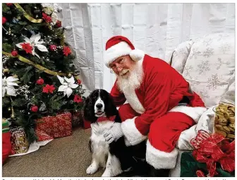  ?? CONTRIBUTE­D ?? Santa assured his buddy Mac that he had made the “nice” list at the recent SantaPaws event hosted by the Kettering Parks, Recreation and Cultural Arts Department.