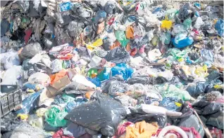  ??  ?? LEFT Garbage is piled in a landfill near the UBQ factory in Kibbutz Zeelim.