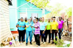  ?? ?? Marsha Burrell-rose, Developmen­t & Marketing Manager, Food for The Poor (top left), Kathryn Silvera, Director of Sales & Marketing (second left), Mr Williams, son of recipient (third left), and team members of Chas. E. Ramson Limited as well as Food for The Poor.