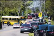  ?? BRIANNA PACIORKA — KNOXVILLE NEWS SENTINEL VIA AP ?? Police work in the area of Austin-East Magnet High School after a reported shooting Monday. Authoritie­s say multiple people including a police officer have been shot at the school.