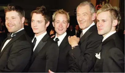  ??  ?? ●●Dominic Lord of the Rings with co-stars Sean Astin, Elijah Wood, Billy Boyd and Ian McKellen after the 2004 Academy Award