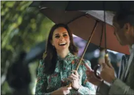  ?? KIRSTY WIGGLESWOR­TH — THE ASSOCIATED PRESS FILE ?? In this Wednesday file photo Britain’s Prince William and his wife Kate, Duchess of Cambridge smile as they walk through the memorial garden in Kensington Palace, London.