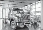  ?? TANNEN MAURY/EPA ?? Trucks are displayed in the lobby of the corporate headquarte­rs of Navistar Internatio­nal Corp. in Lisle, Illinois. Volkswagen AG will pay $256 million for a 16.6 percent share in the company and two seats on the board.