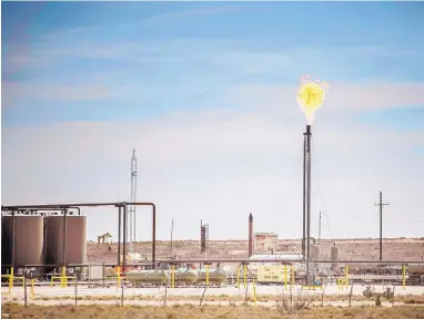  ?? ROBERTO E. ROSALES/JOURNAL ?? Methane flares from a drilling rig near Jal. The EPA says methane emissions dropped by 6 percent in New Mexico, but some question the data’s accuracy.