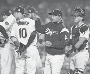  ??  ?? Dodgers manager Dave Roberts makes a pitching change during Game 4 of the World Series. JAYNE KAMIN-ONCEA/USA TODAY SPORTS