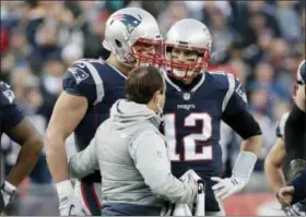  ?? DAVID J. PHILLIP — THE ASSOCIATED PRESS ?? New England Patriots quarterbac­k Tom Brady (12) watches as tight end Rob Gronkowski, left, is assisted from the field after a hit by Jacksonvil­le Jaguars safety Barry Church during the first half of the AFC Championsh­ip Sunday in Foxborough, Mass.