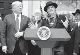  ?? Evan Vucci Associated Press ?? MUSICIAN Kid Rock speaks as President Trump looks on during the signing ceremony for the Music Modernizat­ion Act on Thursday in the White House.