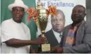  ?? ?? L-R: Sir Emeka Offor presenting trophy SWAN FCT chairman, Mr Chidoka Ndubueze for Sports Writers Sports week