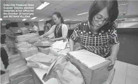  ?? Cebu City Treasurer Diwa Cuevas checks election materials at her office for the October 28 barangay poll. REYNAN VILLENA ??
