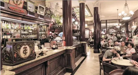  ?? PHOTOS: DINA MISHEV/ FOR THE WASHINGTON POST ?? A little taste of France in Buenos Aires: Cafe Tortoni’s marble-topped tables and historic photos were inspired by Paris coffee houses.