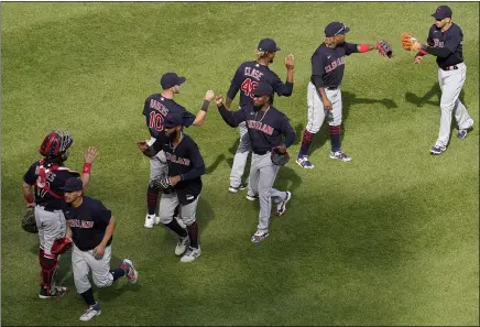  ?? NAM Y. HUH — THE ASSOCIATED PRESS ?? Indians players celebrate after beating the White Sox on May 2in Chicago.