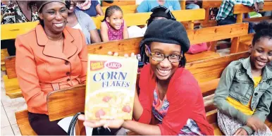  ?? CONTRIBUTE­D ?? This young lady was all smiles when she was gifted for asking pertinent questions during the Jamaica Productivi­ty Centre/LASCO career developmen­t session, held during Youth Week at Grace Apostolic Church in Mandeville, Manchester.