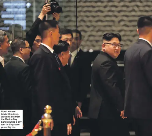  ?? EPA ?? North Korean leader Kim Jongun walks out from the Marina Bay Sands during a city tour in Singapore yesterday