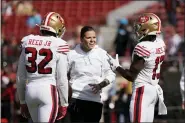  ?? TONY AVELAR — THE ASSOCIATED PRESS FILE ?? San Francisco 49ers assistant Katie Sowers talks with free safety D.J. Reed (32) and wide receiver Richie James (13) before an NFL football game against the Carolina Panthers in Santa Clara in this Sunday, Oct. 27, 2019, file photo.