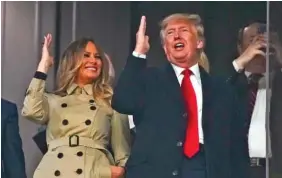  ?? AP PHOTO/DAVID J. PHILLIP ?? Former President Donald Trump and his wife, Melania, perform the tomahawk chop Saturday before for Game 4 of the World Series between the Houston Astros and the Atlanta Braves in Atlanta.