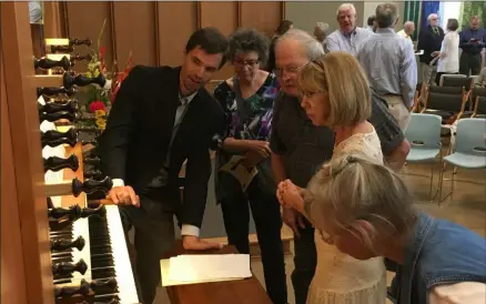  ?? RICHARD PAYERCHIN — THE MORNING JOURNAL ?? First Lutheran Church Music Director Brian Wentzel explains the workings of the church’s new organ, which was dedicated with a recital on Aug. 25, 2019. The new organ, built by Paul Fritts & Co. of Tacoma, Wash., replaces the organ destroyed in the fire of Aug. 28, 2014.