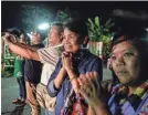  ?? LAUREN DECICCA/GETTY IMAGES ?? Onlookers cheer as ambulances deliver boys rescued from a cave in northern Thailand to a hospital.