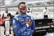  ?? WILFREDO LEE / AP ?? Bubba Wallace, NASCAR’s only black full-time Cup driver, stands for Sunday’s national anthem.