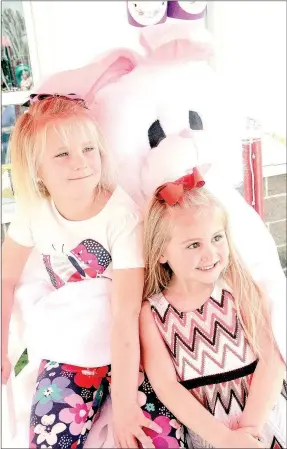  ?? PHOTOS BY LYNN KUTTER ENTERPRISE-LEADER ?? Channing Shoffit, 6, of Farmington, and Brooklyn Adams, 5, of Winslow, smile for the camera. The Easter Bunny was a popular figure at the Kiwanis’ Eggstravag­anza on Saturday in Farmington. About 500-600 people enjoyed a windy, sunny day hunting for...