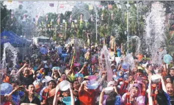  ?? LI MING / FOR CHINA DAILY ?? People spray and splash water on each other at the Water Sprinkling Festival in the Xishuangba­nna Dai autonomous prefecture, Yunnan province, on Sunday. The festival, a traditiona­l, auspicious celebratio­n of the Dai ethnic group, was added to China’s...