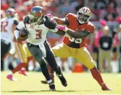  ?? NHAT V. MEYER/STAFF ?? The 49ers’ Aaron Lynch, right, trying to sack Bucs quarterbac­k Jameis Winston, is listed as questionab­le.