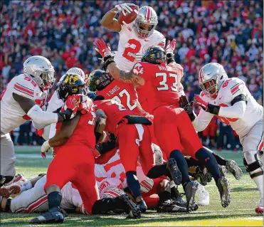  ?? WILL NEWTON PHOTOS / GETTY IMAGES ?? Ohio State’s J.K. Dobbins scores during the first half Saturday at Capital One Field in College Park, Maryland. Dobbins had 203 yards on 37 carries, both career highs.