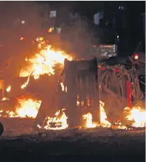  ?? PHOTO: AP ?? Carnage . . . Cars burn after 25 people were killed in a powerful explosion early yesterday in the Somali capital, Mogadishu. .