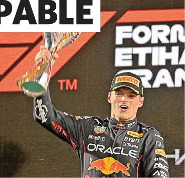  ?? (AFP) ?? Red Bull's Max Verstappen celebrates with the trophy after the Abu Dhabi Formula One Grand Prix on Sunday